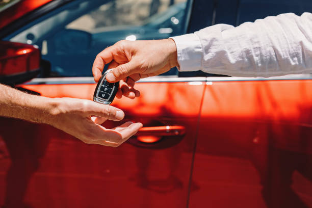 A man receiving car keys for a rental vehicle.